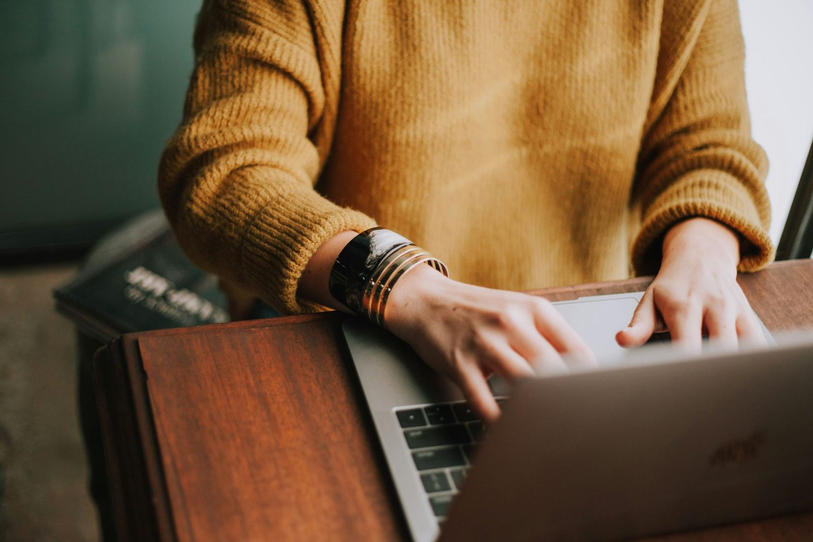 An image of a woman typing at her laptop for her own law firm